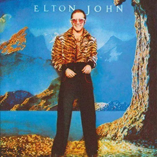 Front cover of Elton John’s 1974 album Caribou on vinyl LP, featuring original artwork and classic rock tracks like “The Bitch Is Back.”