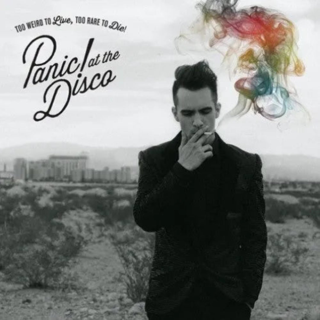 Brendon Urie standing in a smoky desert scene on the album’s striking cover
