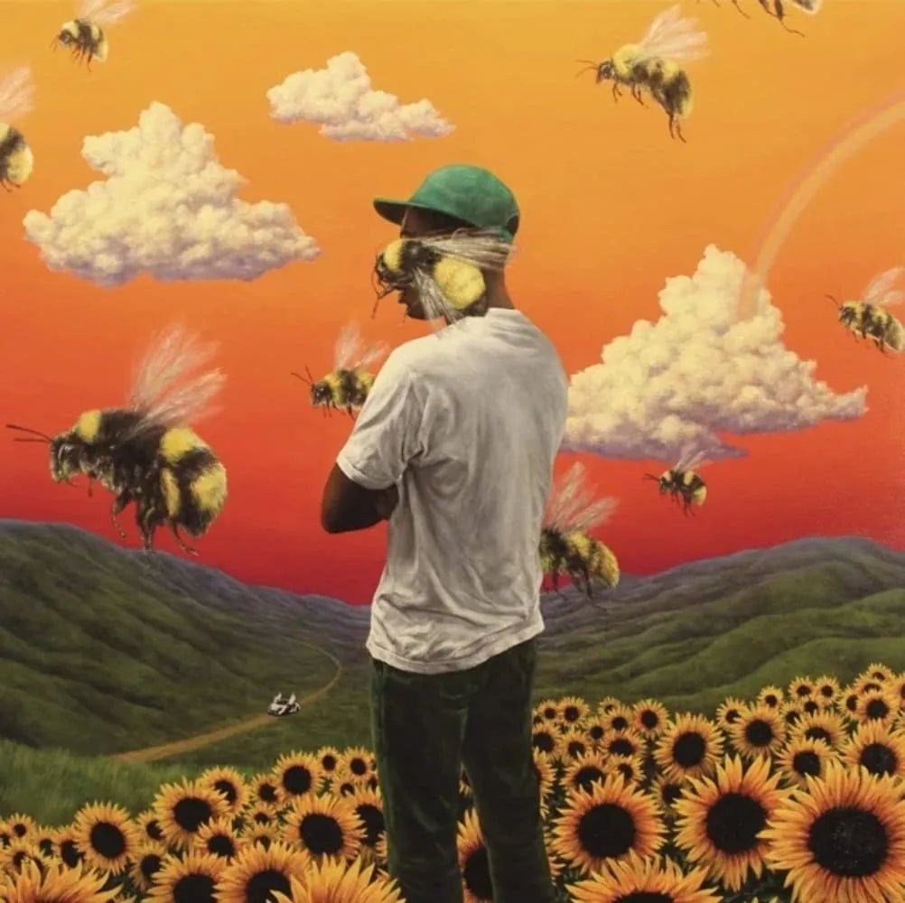 Flower Boy vinyl artwork with Tyler standing in a vivid sunflower field under a warm sky