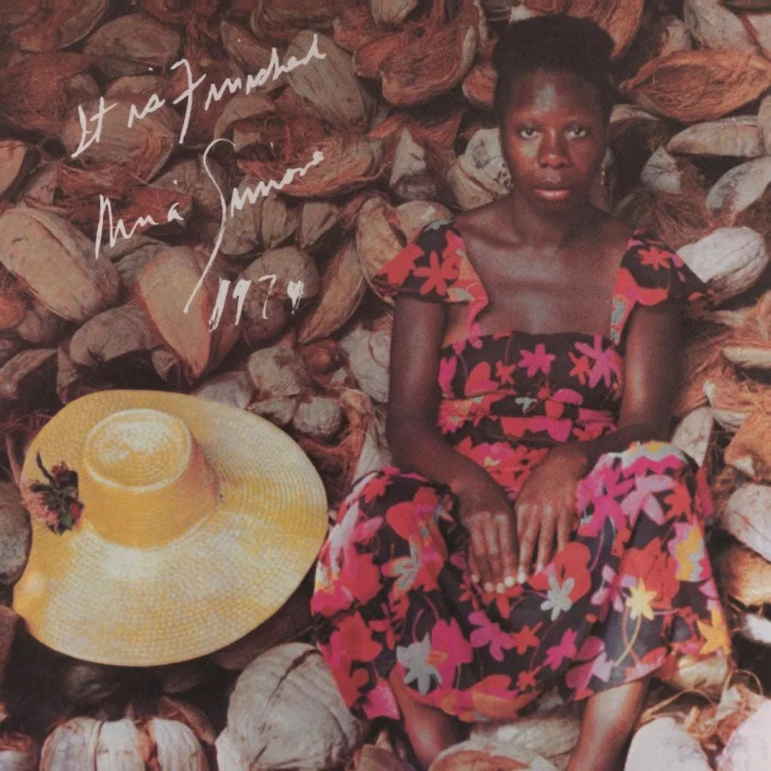Nina Simone performing live with vibrant world instruments in an expressive concert setting