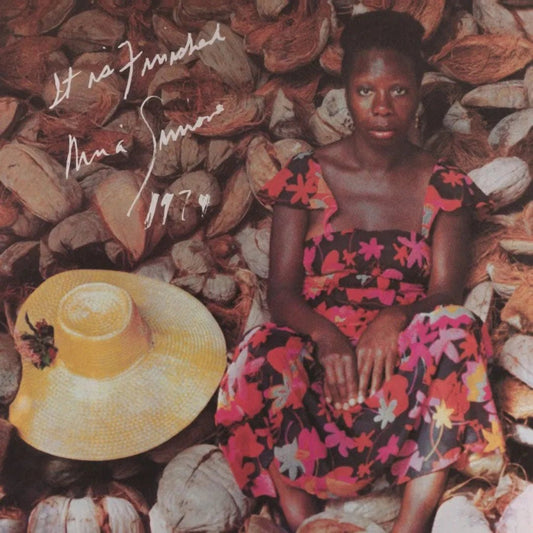 Nina Simone performing live with vibrant world instruments in an expressive concert setting